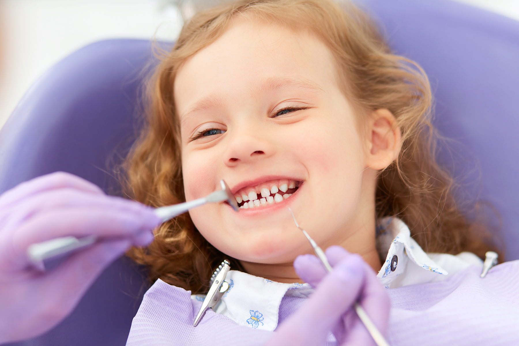 Little girl getting a pediatric dental exam in West Fargo, ND