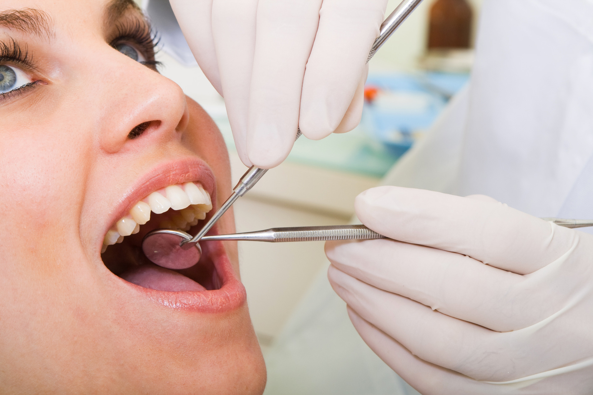 Happy woman being examined before a dental extraction in Fargo ND