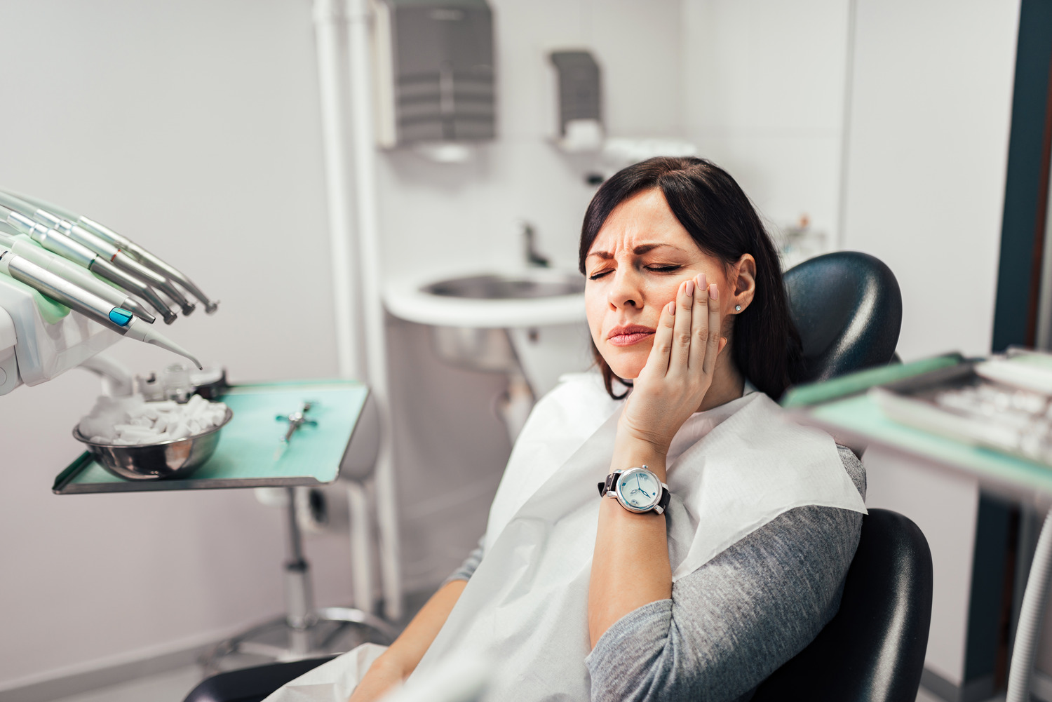 Woman with tooth pain is at an emergency dental visit in Fargo ND